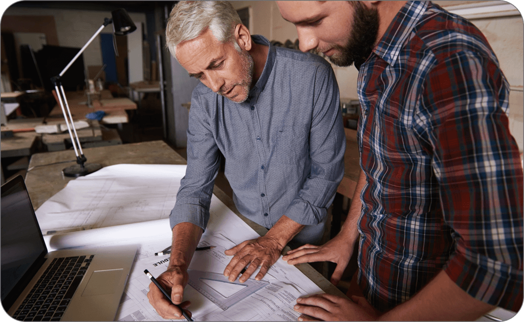 Two men working on project designs