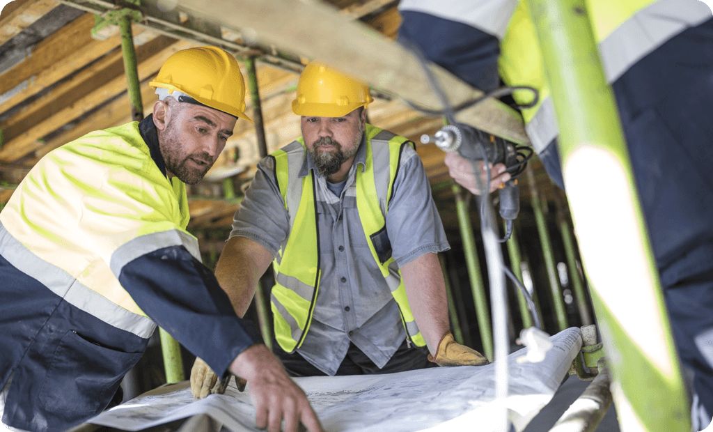 Men in hard hats looking at designs